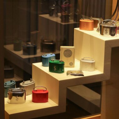 Elegant retail display showcasing luxury watches on stacked shelves in a storefront window.